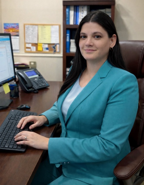 Alidea “Allie” Jurchelea at her desk at the permit office in Dania Beach